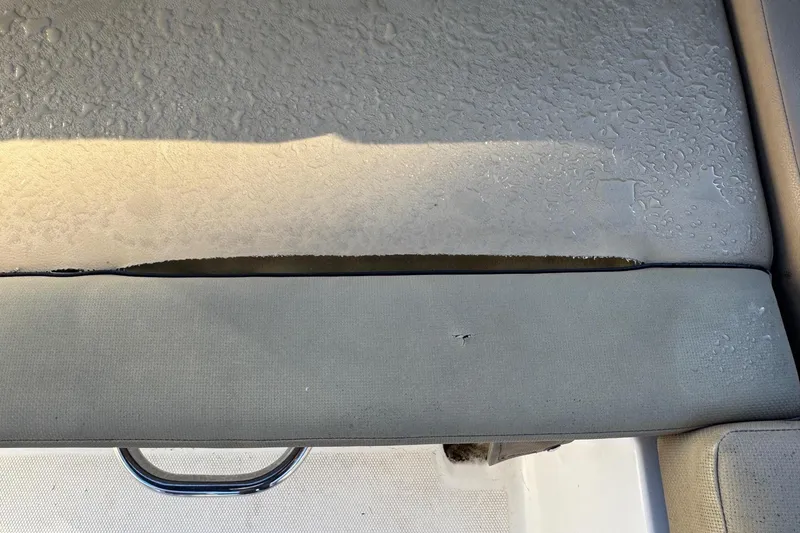 Slide: The Image of 2022 Bayliner VR6 Bowrider OB interior with tan seating and sleek design. - 21