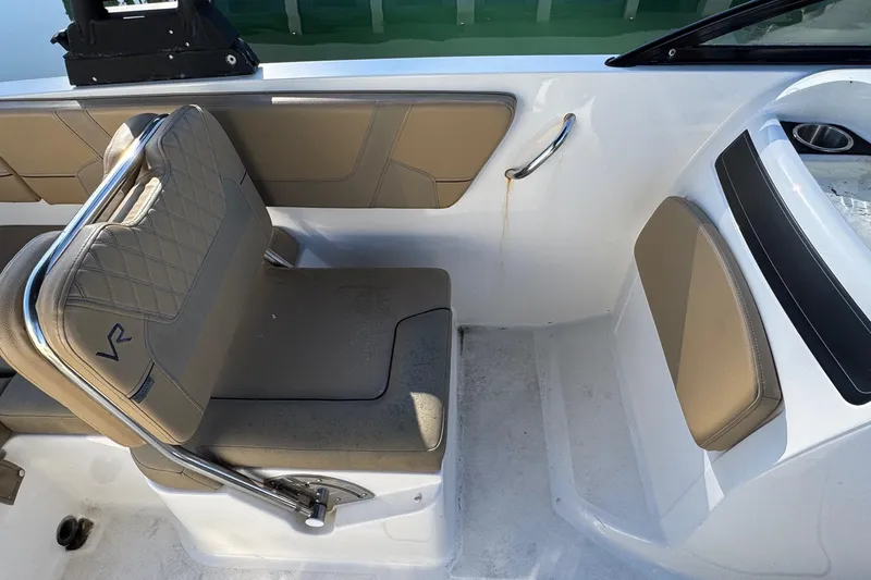 Slide: The Image of 2022 Bayliner VR6 Bowrider OB interior with tan seating and storage compartment. - 27