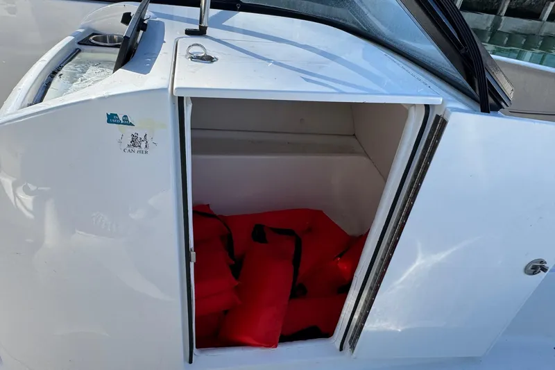 Slide: The Image of 2022 Bayliner VR6 Bowrider OB interior with tan seating and steering wheel. - 35