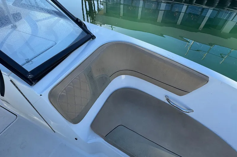 Slide: The Image of 2022 Bayliner VR6 Bowrider OB at marina, showcasing helm and seating area. - 44