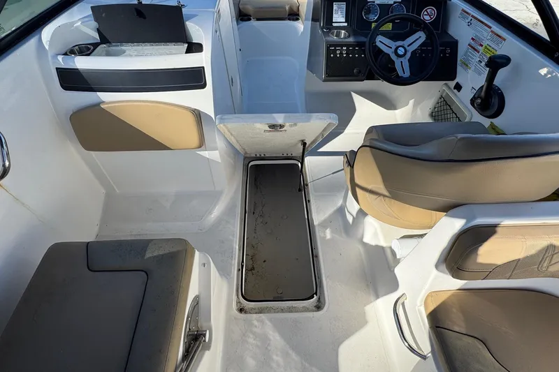 Slide: The Image of 2022 Bayliner VR6 Bowrider OB with tan seating, docked by calm water. - 45