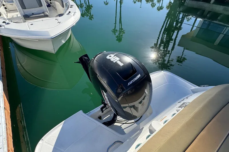 Slide: The Image of 2022 Bayliner VR6 Bowrider OB interior with tan seating at marina. - 47