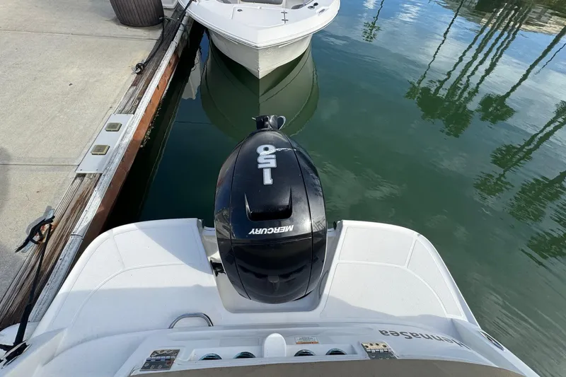 Slide: The Image of 2022 Bayliner VR6 Bowrider OB with Mercury 150 engine docked by the water. - 52