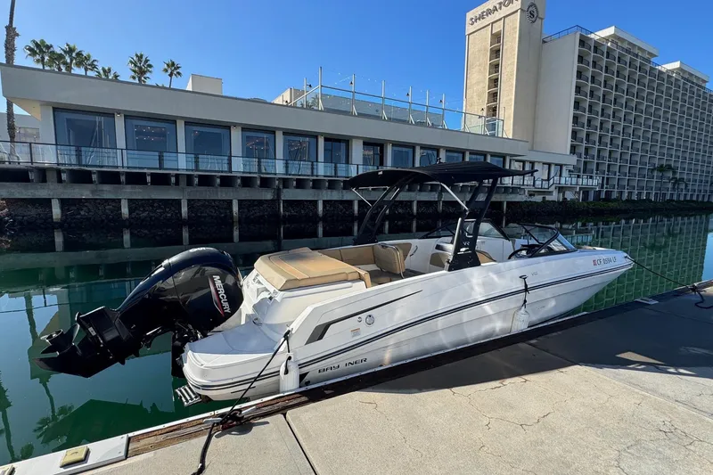 Slide: The Image of 2022 Bayliner VR6 Bowrider OB docked by waterfront hotel. - 6