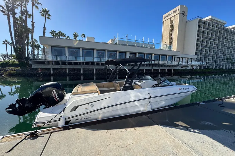 Slide: The Image of 2022 Bayliner VR6 Bowrider OB docked near waterfront hotel. - 7