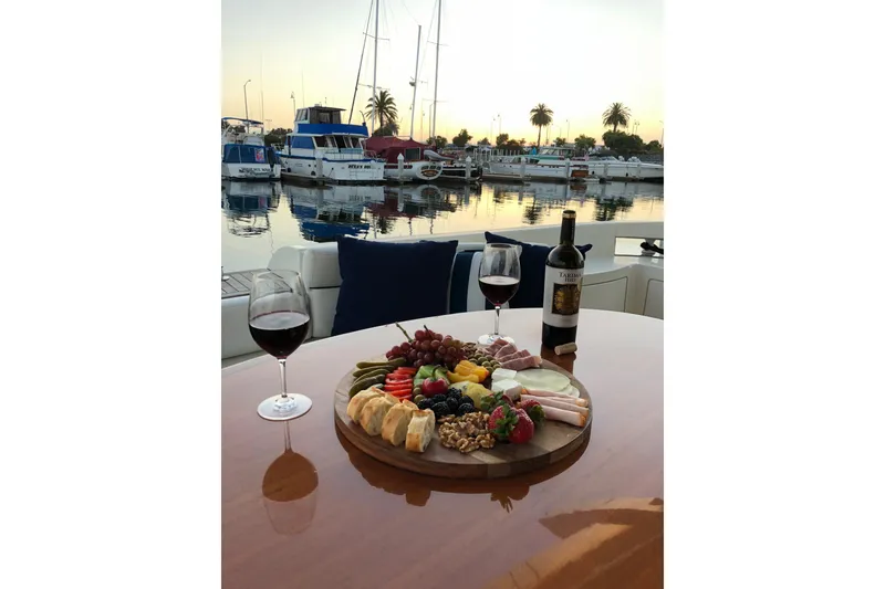 Slide: The Image of Luxurious dining setup on 2007 Azimut 62 Evolution yacht with wine and charcuterie. - 15