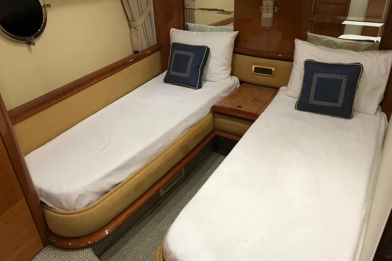 Slide: The Image of Twin cabin interior of 2007 Azimut 62 Evolution yacht with elegant bedding and wood accents. - 19