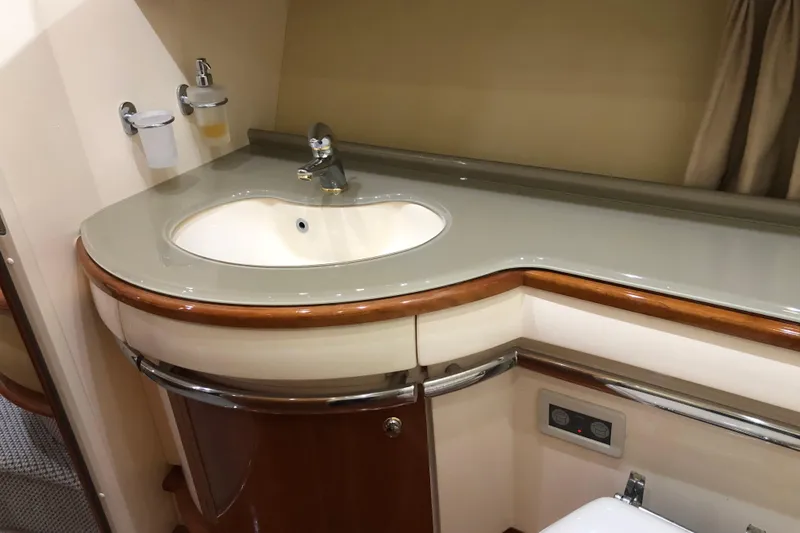 Slide: The Image of Luxurious bathroom sink in 2007 Azimut 62 Evolution yacht, featuring elegant wood accents. - 22