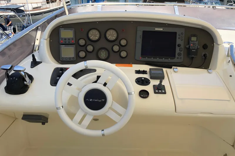 Slide: The Image of Helm of 2007 Azimut 62 Evolution yacht with steering wheel and navigation controls. - 30
