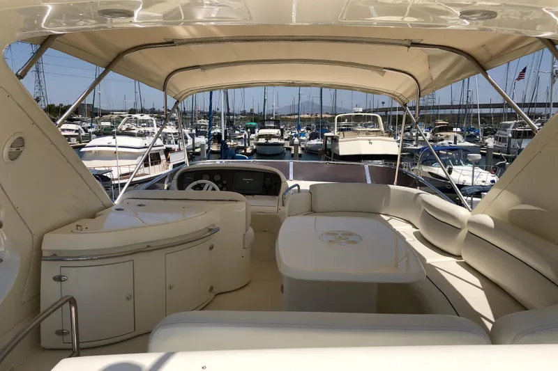 Slide: The Image of Luxurious 2007 Azimut 62 Evolution yacht interior at marina, featuring elegant seating and helm. - 33