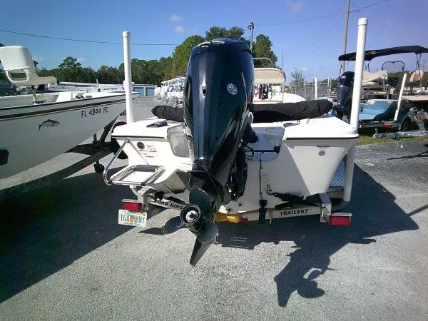 Slide: The Image of 2022 Carolina Skiff JLS 178 boat with outboard motor, parked on a trailer. - 3