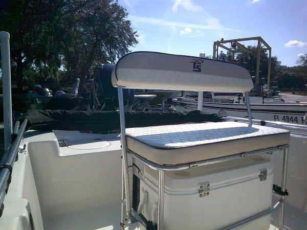 Slide: The Image of 2022 Carolina Skiff JLS 178 boat interior with cushioned seating and storage. - 4