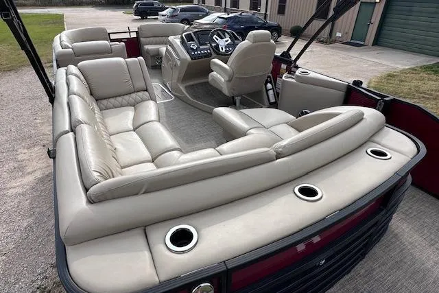 Slide: The Image of 2015 Bennington 2350 QCL pontoon boat with luxurious seating and modern dashboard. - 13