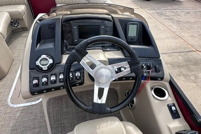 Slide: The Image of 2015 Bennington 2350 QCL boat dashboard with steering wheel and control panel. - 15