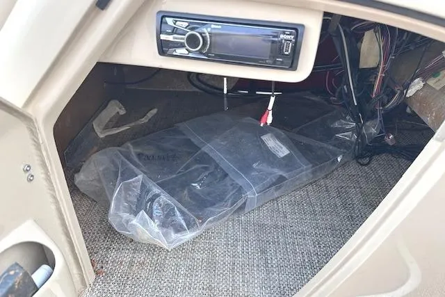 Slide: The Image of 2015 Bennington 2350 QCL boat interior with audio system and wiring. - 21