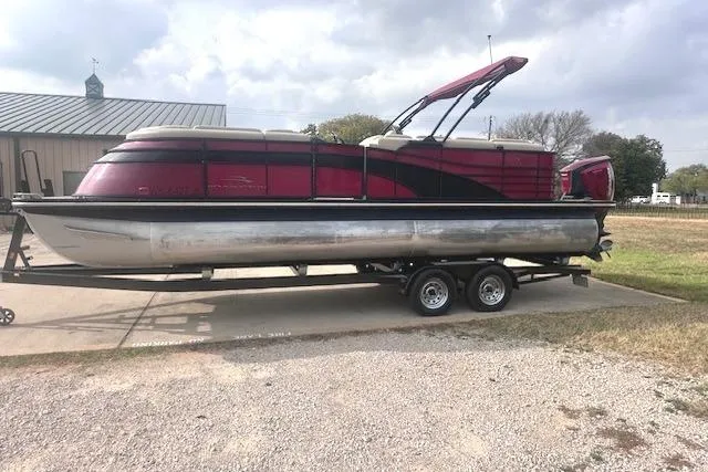 Slide: The Image of 2015 Bennington 2350 QCL pontoon boat on trailer, parked outdoors. - 4