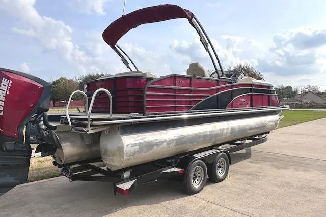 Slide: The Image of 2015 Bennington 2350 QCL pontoon boat on trailer, featuring red and silver design. - 6