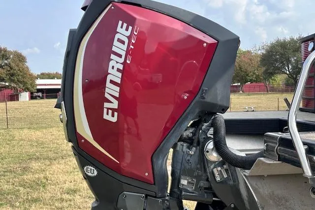 Slide: The Image of Red Evinrude E-TEC outboard motor on 2015 Bennington 2350 QCL boat, outdoor setting. - 7