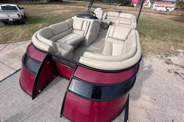 Slide: The Image of 2015 Bennington 2350 QCL pontoon boat with spacious seating and red-black exterior. - 8