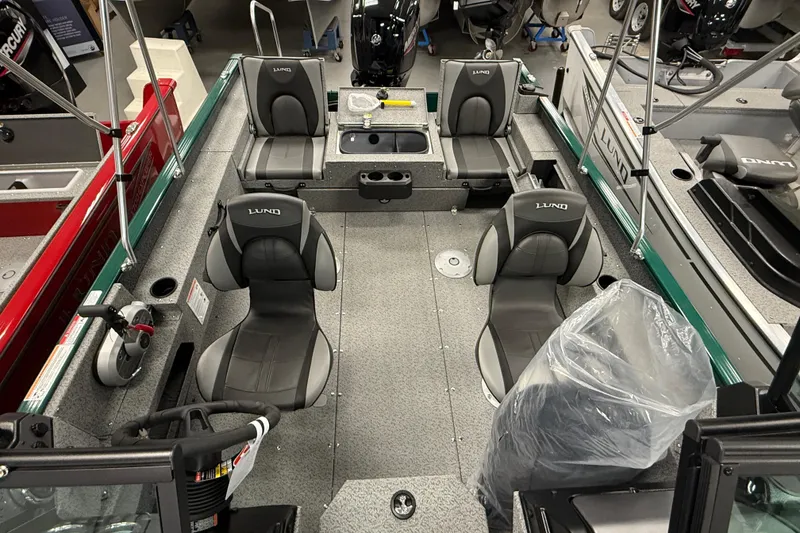 Slide: The Image of 2026 Lund 1775 Adventure Sport boat interior with seating and steering wheel. - 14