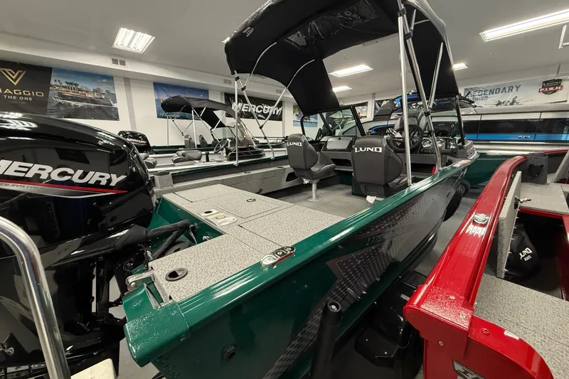 Slide: The Image of 2026 Lund 1775 Adventure Sport boat with Mercury engine in showroom display. - 4