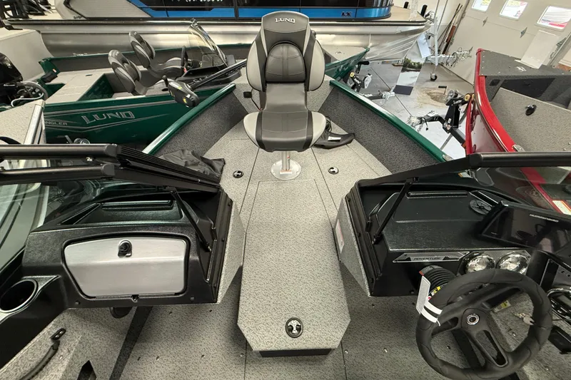 Slide: The Image of 2026 Lund 1775 Adventure Sport boat interior with seating and dashboard view. - 5