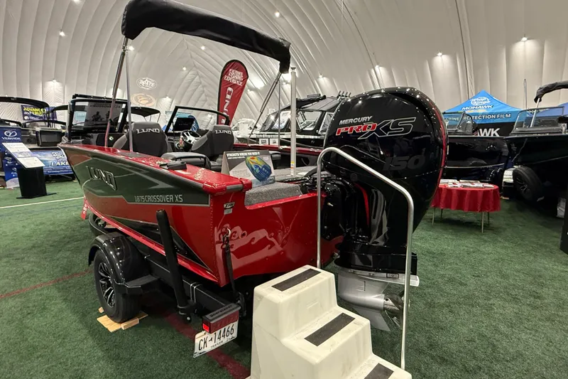 The Image of 2026 Lund Crossover XS 1875 boat with Mercury Pro XS engine on display indoors. - 0