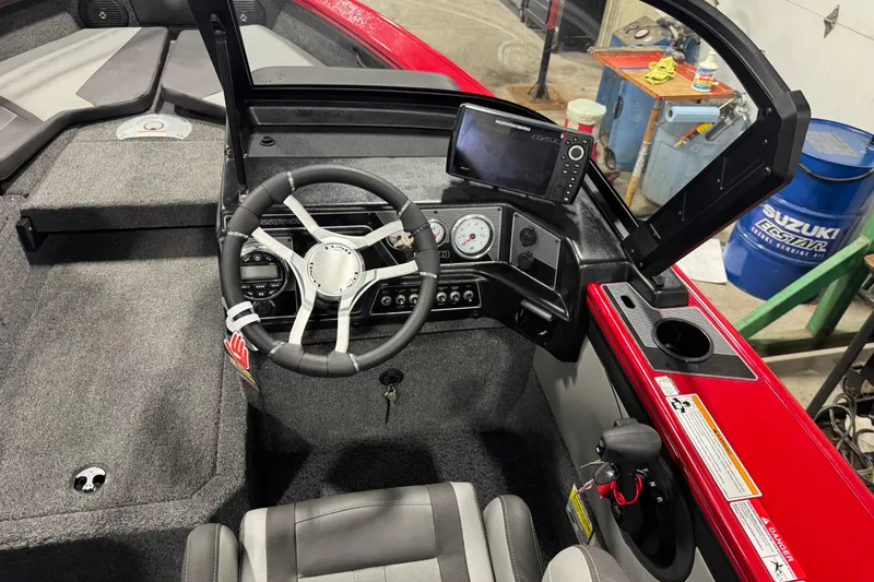 Slide: The Image of 2026 Lund Crossover XS 1875 boat in a garage, featuring dual consoles and a Mercury outboard motor. - 5