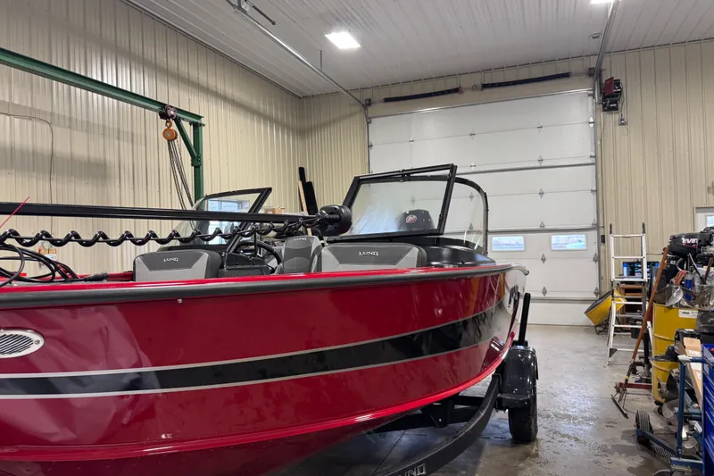 Slide: The Image of 2026 Lund Crossover XS 1875 boat in a garage with Mercury Pro XS engine. - 9