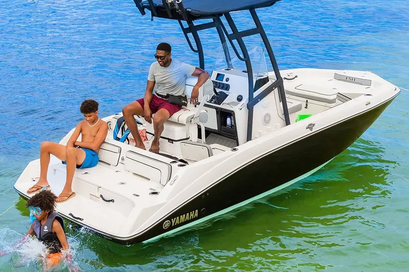 Slide: The Image of 2023 Yamaha Boats 190 FSH Sport on water with people enjoying a sunny day. - 4