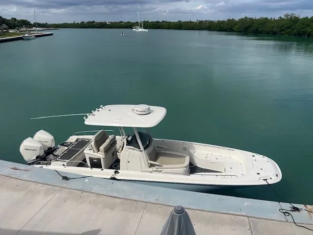 Slide: The Image of 2022 Boston Whaler DAUNTLESS boat docked on calm turquoise water. - 3