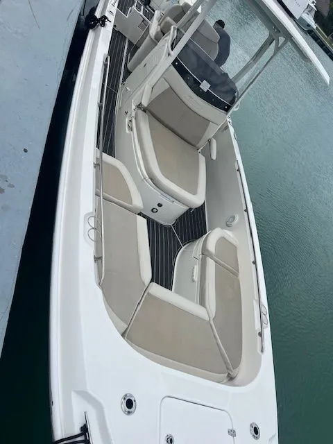 Slide: The Image of 2022 Boston Whaler DAUNTLESS boat with spacious seating, docked on calm water. - 4