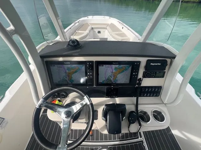 Slide: The Image of 2022 Boston Whaler DAUNTLESS helm with dual navigation screens and steering wheel. - 8