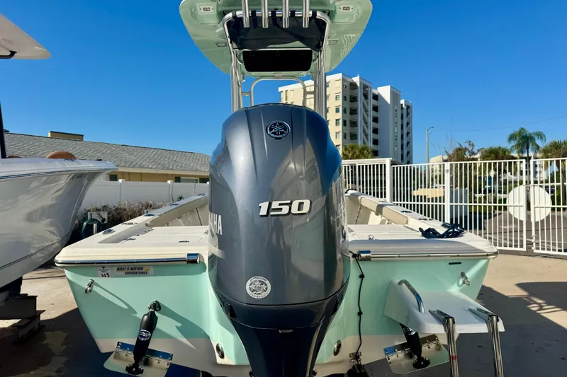Slide: The Image of 2023 Key West 210 Bay Reef boat with Yamaha 150 engine, docked outdoors. - 13