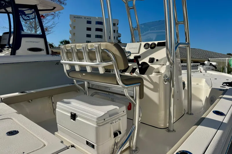 Slide: The Image of 2023 Key West 210 Bay Reef boat interior with console and seating, docked near Marina Place. - 16