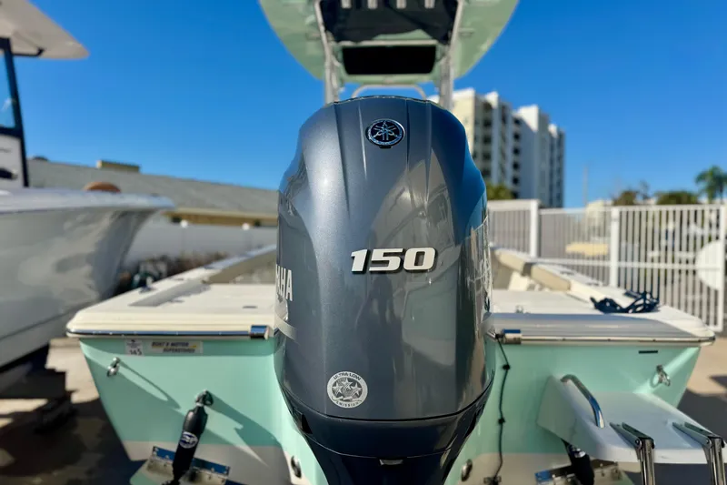 Slide: The Image of 2023 Key West 210 Bay Reef with Yamaha 150 outboard motor, docked outdoors. - 18
