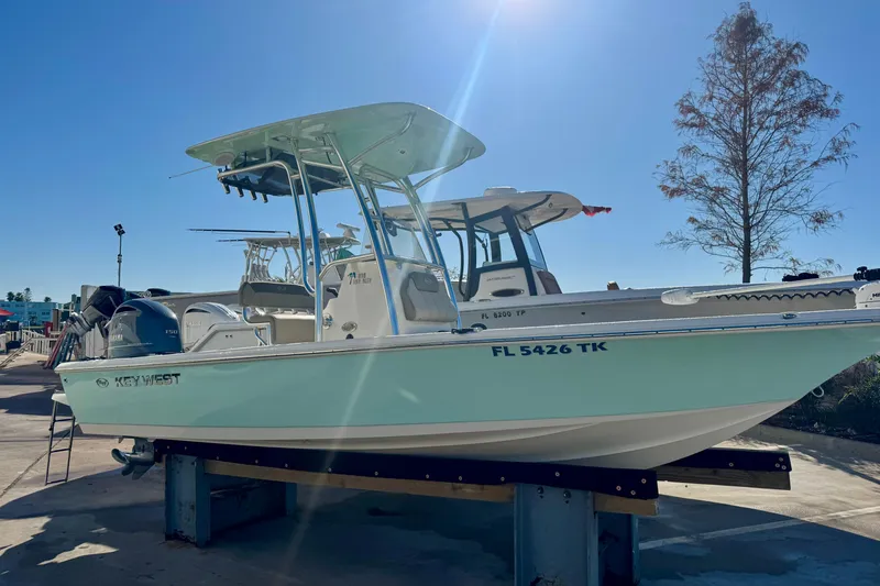 Slide: The Image of 2023 Key West 210 Bay Reef boat on display under clear blue sky. - 2