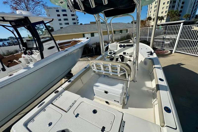 Slide: The Image of 2023 Key West 210 Bay Reef boat with center console and seating, docked outdoors. - 21