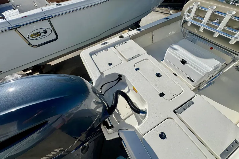 Slide: The Image of 2023 Key West 210 Bay Reef boat interior with Yamaha engine and storage compartments. - 22