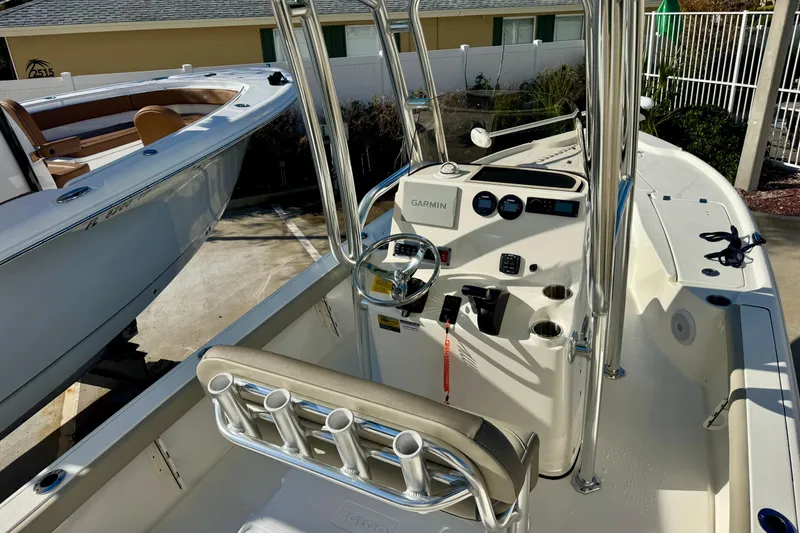 Slide: The Image of 2023 Key West 210 Bay Reef boat interior with steering console and rod holders. - 26