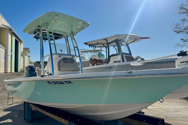 Slide: The Image of 2023 Key West 210 Bay Reef boat docked under clear blue sky. - 3