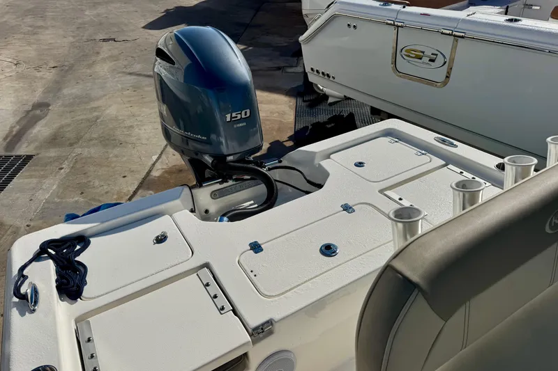 Slide: The Image of 2023 Key West 210 Bay Reef boat with Yamaha 150 engine, docked outdoors. - 30