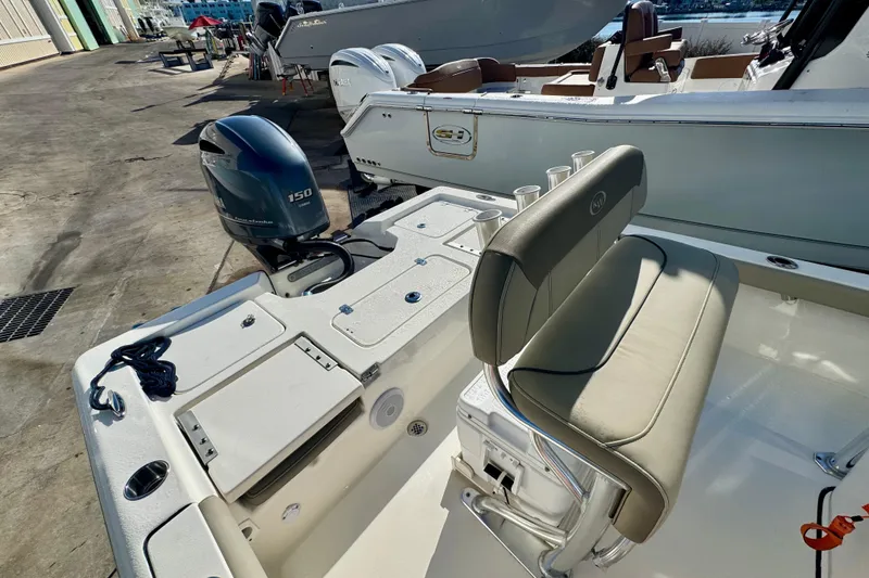 Slide: The Image of 2023 Key West 210 Bay Reef boat with Yamaha 150 engine, docked at marina. - 31