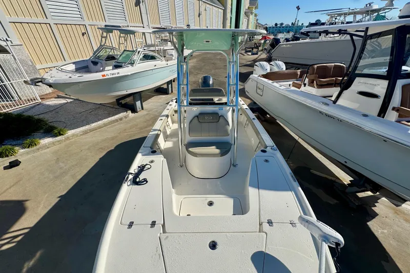 Slide: The Image of 2023 Key West 210 Bay Reef boat displayed in a marina with other vessels. - 37