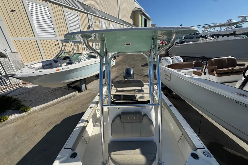 Slide: The Image of 2023 Key West 210 Bay Reef boat with T-top, docked alongside other boats. - 39