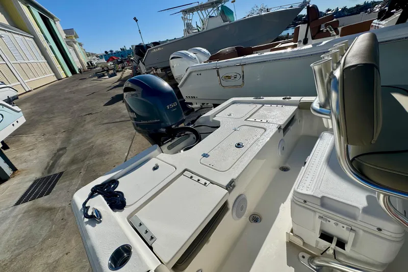 Slide: The Image of 2023 Key West 210 Bay Reef boat with Yamaha 150 engine at a marina. - 45