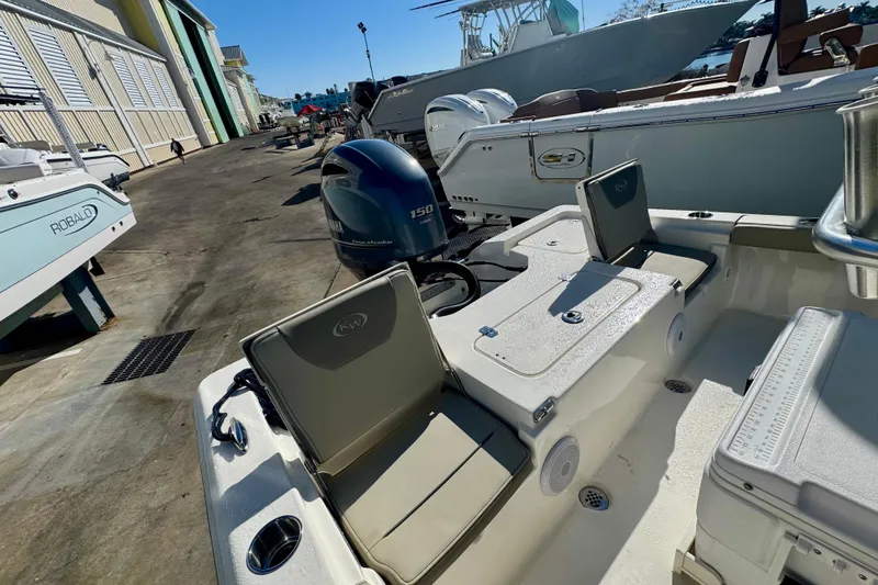 Slide: The Image of 2023 Key West 210 Bay Reef boat with Yamaha 150 engine in marina setting. - 46
