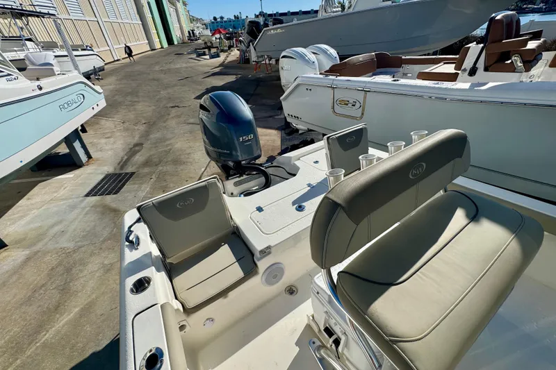 Slide: The Image of 2023 Key West 210 Bay Reef boat with Yamaha 150 engine, docked at marina. - 47