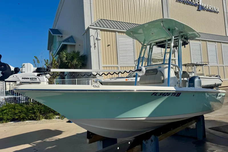 Slide: The Image of 2023 Key West 210 Bay Reef boat with Minn Kota motor at a marina. - 6