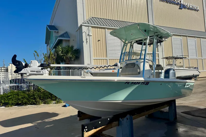Slide: The Image of 2023 Key West 210 Bay Reef boat with Minn Kota motor, docked at a marina. - 7
